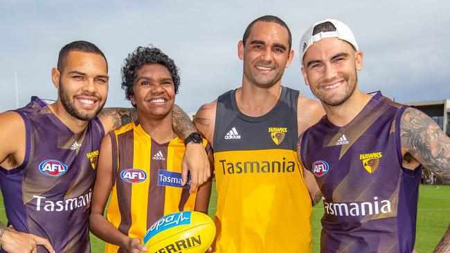 Former Port Adelaide stars Jarman Impey, Shaun Burgoyne and Chad Wingard with Ceberio Johnson, Hawthorn’s Number 1 fan, from Tenant Creek. Picture: Sarah Matray