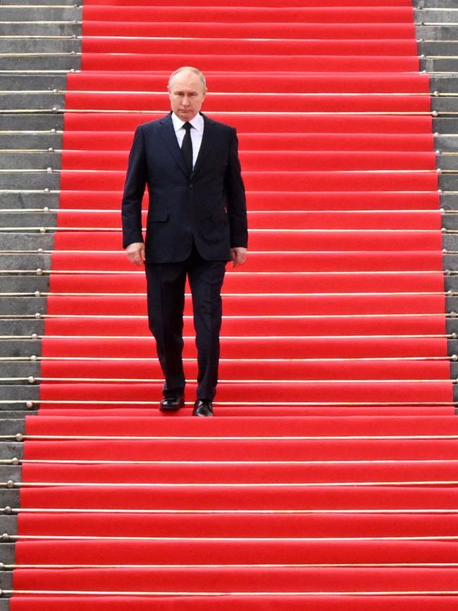 Russian President Vladimir Putin walks down the steps to address troops overnight (AEST). Picture: AFP