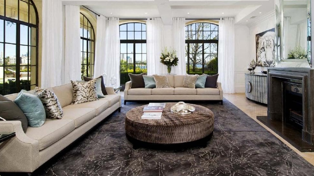 A sitting area with windows overlooking the waterfront.