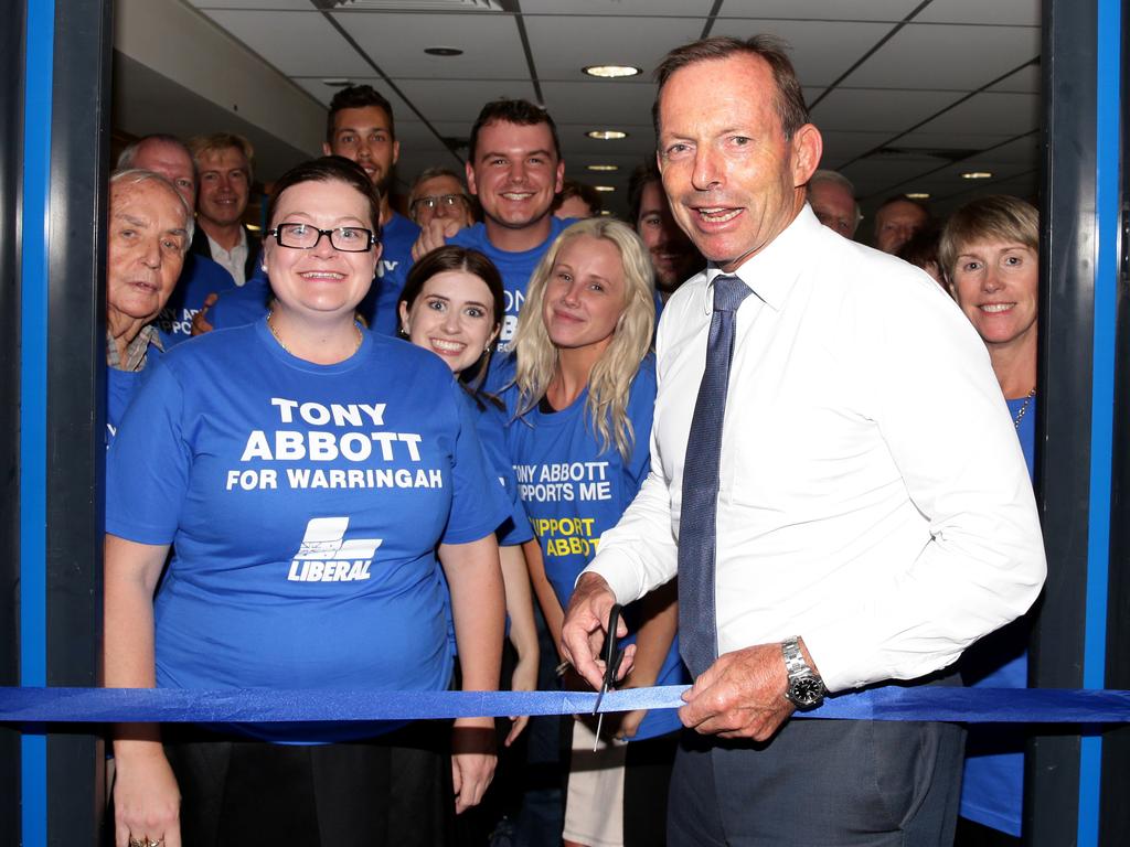 Tony Abbott cutting a ribbon to Brookvale campaign office launch. Picture Jonathan Ng