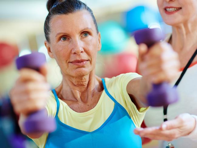 Warm-up of active senior woman in gym. Istock