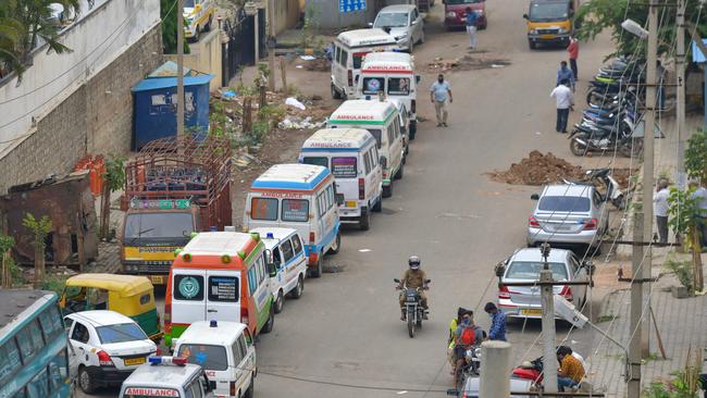 Ambulances wait to deliver victims of the coronavirus to a crematorium in Bangalore on Wednesday. Picture: AFP