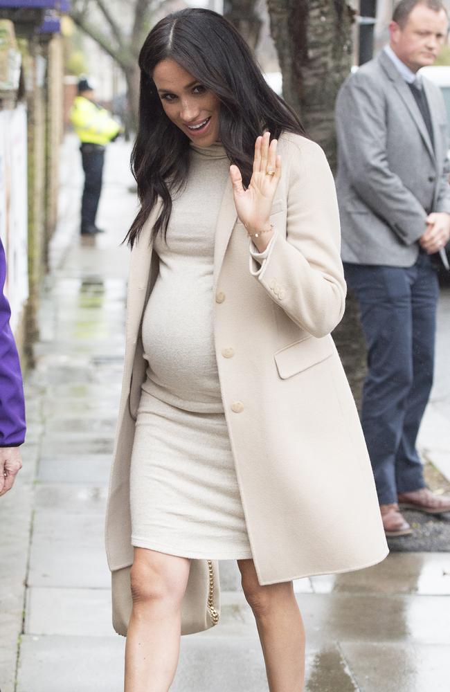 The Duchess of Sussex paired an Armani coat with a fitted dress from H&M for an appearance in London. Picture: Eddie Mulholland/Getty