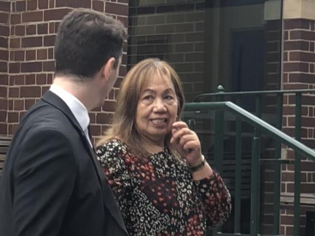 Daisy Aben, 67, an aged care worker from Blacktown, outside Manly Local Court with a solicitor on Wednesday, where she is facing 72 counts of dishonestly obtain financial advantage for allegedly withdrawing money using a bank credit card that was not hers. Picture: Manly Daily