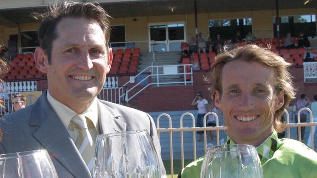 Neil Pinner (left) and Damien Oliver celebrat an Ellicorsam victory in 2004. Picture: Graeme Collopy