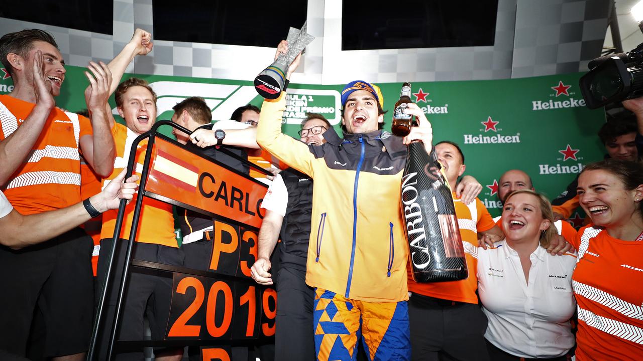 Carlos Sainz and McLaren celebrate after later being awarded third place in Brazil.