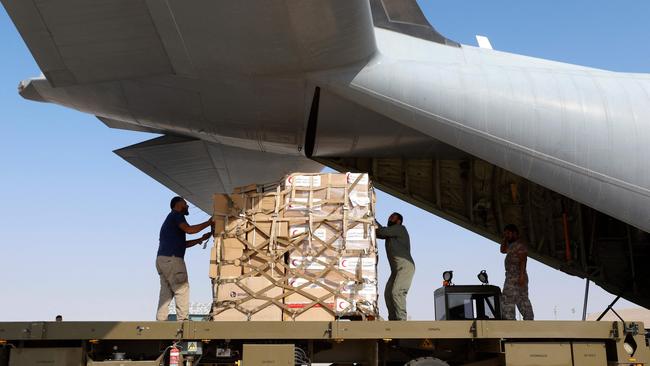 Humanitarian assistance to be sent to the Gaza Strip is loaded into a Qatari army plane at the Al-Udeid air base in Qatar this week. Picture: AFP