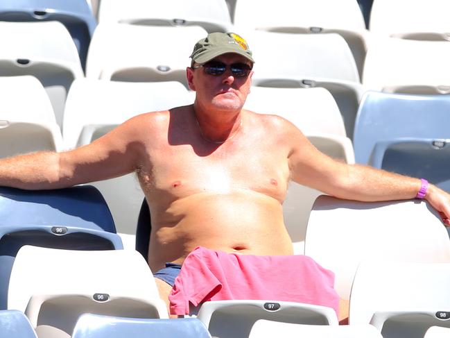 A spectator enjoys the warm weather during an Australian Open at Melbourne Park.The heat will be on again this week. Picture: David Crosling