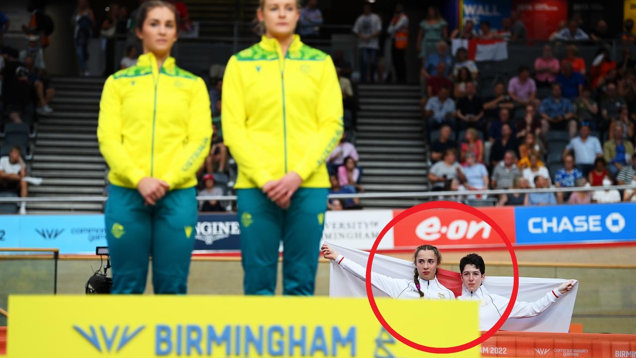 Sophie Unwin and Georgia Holt of Team England stand with their flag behind the podium. Photo by Justin Setterfield/Getty Images.