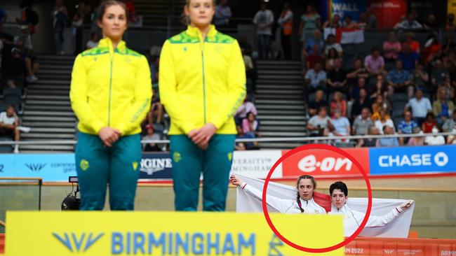 Sophie Unwin and Georgia Holt of Team England stand with their flag behind the podium. Photo by Justin Setterfield/Getty Images.