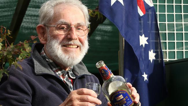 World War II veteran, Fred Bottrell, 93, gets ready to toast his mates with a glass of British navy rum. Picture: Hamish Blair.