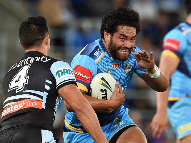 Konrad Hurrell of the Gold Coast Titans (right) is tackled by Gerard Beale of the Cronulla Sharks during their round 21 NRL game at Cbus Super Stadium on the Gold Coast, Monday, Aug. 1, 2016. (AAP Image/Dan Peled) NO ARCHIVING, EDITORIAL USE ONLY