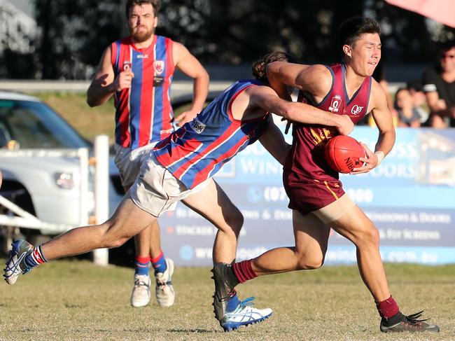 Greensborough recruit Jordan McIvor-Clark lays a tackle in the QAFL. Picture: Richard Gosling