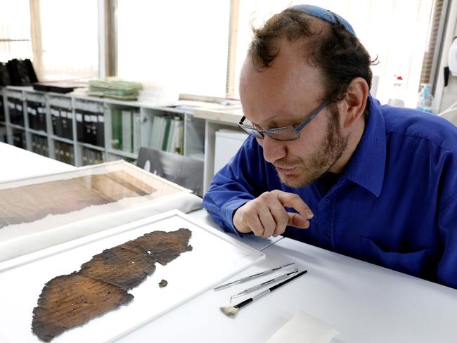 Oren Ableman, the Dead Sea scrolls researcher from the Israel Antiquities Authority, examined scroll fragments with the aid of advanced imaging equipment and revealed a previously unseen script. Picture: Gali Tibbon