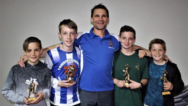 Mr Riddle with players from the Combined Saints team in Traralgon, Victoria.