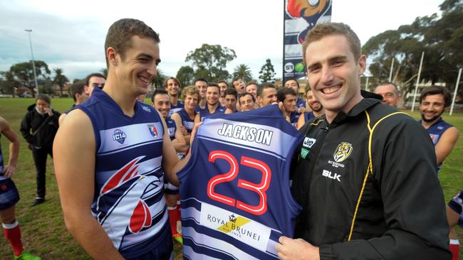 Daniel Jackson (right) is presented a guernsey by French AFL team Les Coqs captain Gregoire Patacq in 2014. Picture: Andrew Henshaw.