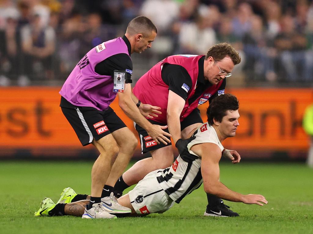 Lachie Schultz collapses in the hands of medical staff after being knocked out. Picture: Paul Kane/Getty Images.