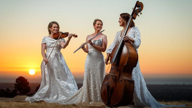 Adelaide Symphony Orchestra musicians Emma Perkins (violin), Lisa Gill (flute) and Belinda Kendall-Smith (double bass) on the Pioneer Women’s Trail in Beaumont. Hair and make-up by M&amp;CO Style Bar, dressed by Gretakate. Picture: Matt Turner.