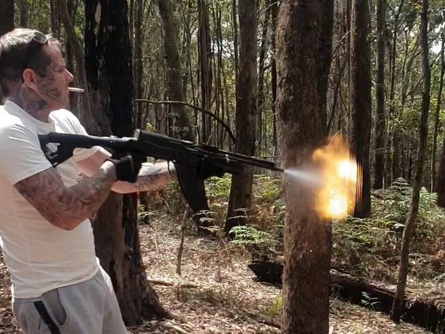 Matthew Bruce firing a military-style SKS assault rifle with his baby daughter nearby.