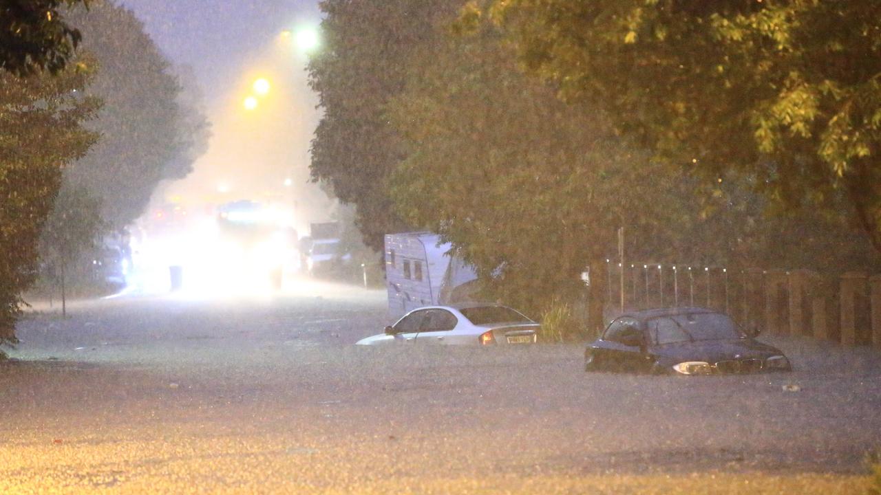 Two cars stuck on a flooded Macpherson Street in Warriewood during heavy Sydney storms.