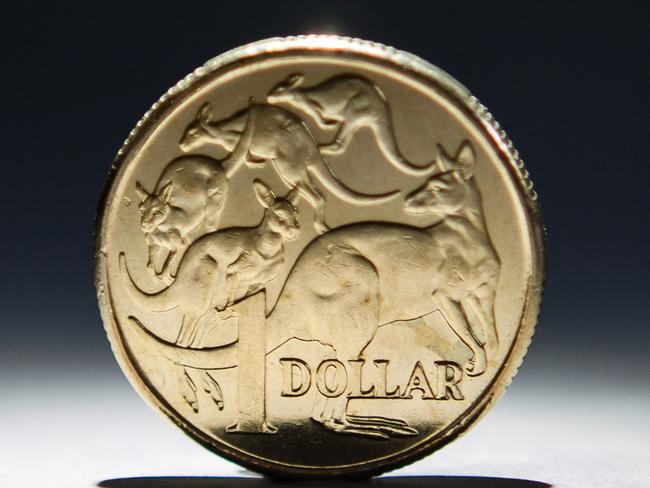 An Australian one-dollar coin is arranged for a photograph in Sydney, Australia, on Wednesday, April 17, 2013. Direct trading between the Australian dollar and yuan started on April 10. Photographer: Ian Waldie/Bloomberg