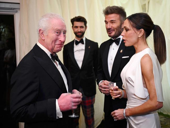 Britain's King Charles III reacts as he meets British fashion designer Victoria Beckham and British Ex-Footballer David Beckham during a dinner celebrating the values of Slow Food and Slow Fashion at Highgrove House in Tetbury western England on February 7, 2025. (Photo by Finnbarr Webster / POOL / AFP)