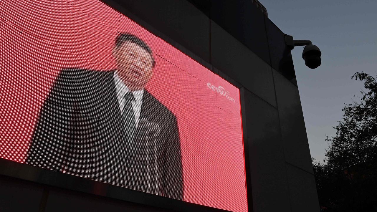 Chinese President Xi Jinping on a TV screen shortly after announcing the new five-year plan. Picture: GREG BAKER / AFP.