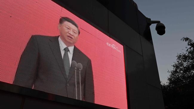 Chinese President Xi Jinping on a TV screen shortly after announcing the new five-year plan. Picture: GREG BAKER / AFP.