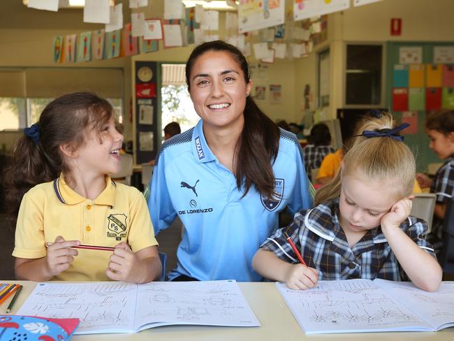 Teresa Polias with students Olivia Lygdas and Ruby Van Bueren at her school last year. Picture: Richard Dobson