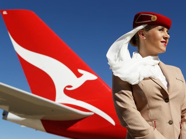 06/09/2012 BUSINESS: An Emirates Airline flight attendant stands in front of a Qantas Airways Ltd. aircraft during a media event in Sydney, Australia, on Thursday, Sept. 6, 2012. Qantas formed an alliance with Emirates to coordinate prices and schedules, while scrapping a similar deal with British Airways, as the carrier tries to reverse losses on long-haul routes. Photographer: Brendon Thorne/Bloomberg Picture: Supplied