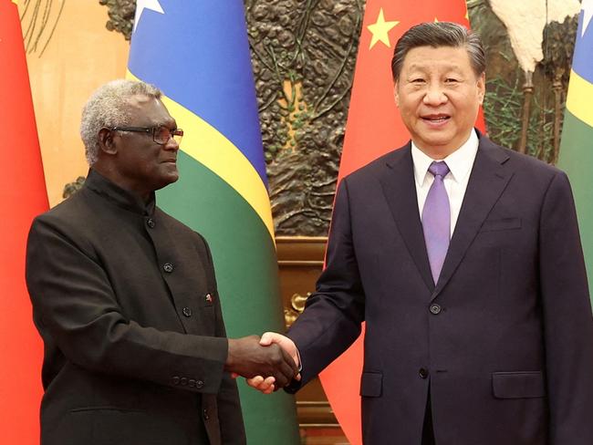 Chinese President Xi Jinping and Solomon Islands Prime Minister Manasseh Sogavare shake hands at the Great Hall of the People in Beijing, China July 10, 2023. cnsphoto via REUTERS   ATTENTION EDITORS - THIS IMAGE WAS PROVIDED BY A THIRD PARTY. CHINA OUT.