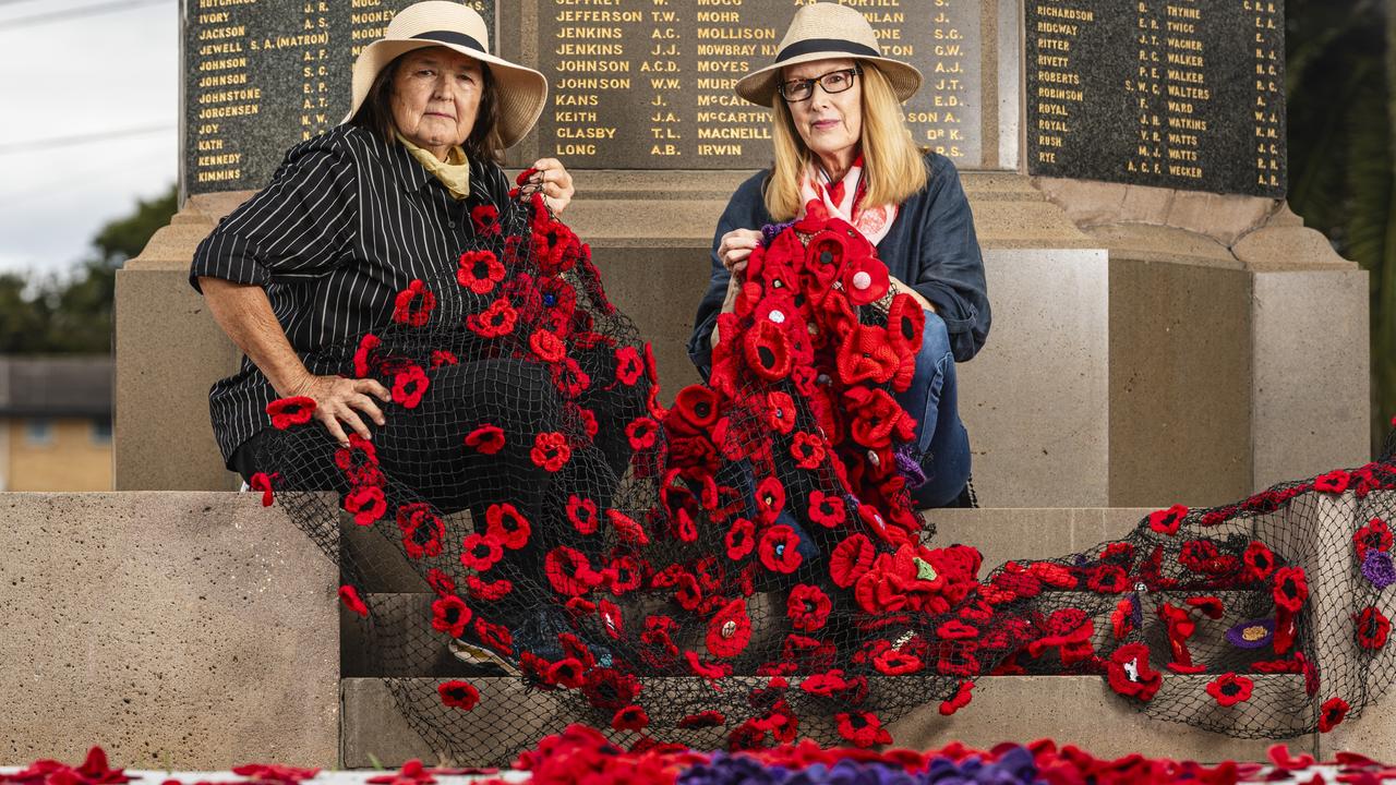 Jayne Hodge (left) and Chris Just install their "Memories in Bloom" with the help of Rotary Club of Toowoomba East at the Mothers' Memorial for Anzac Day, Wednesday, April 24, 2024. Picture: Kevin Farmer