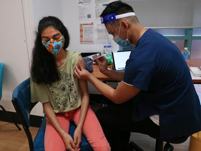 Nurse John Maya administers the Pfizer vaccine to a client at the St Vincent's Covid-19 vaccination clinic in Sydney. Picture: Getty Images