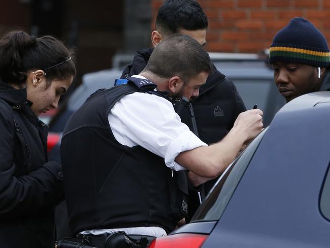 Police officers interview people at the scene. Picture: Getty Images