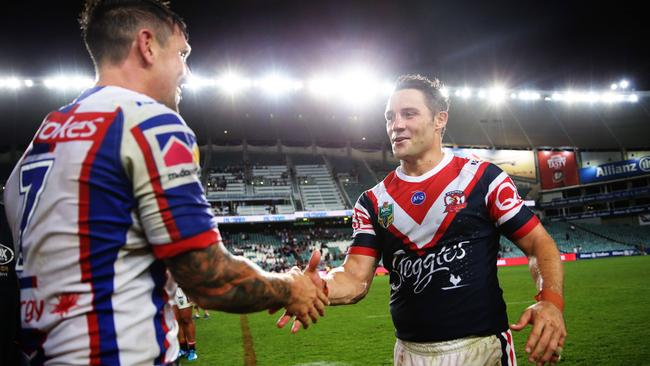 Mitchell Pearce and Cooper Cronk shake hands after the Roosters’ win over Newcastle at Allianz Stadium. Picture: Brett Costello