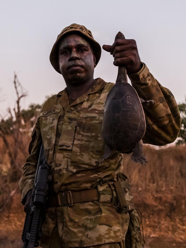 Private Blake Djammarr Carter catches a river turtle for tucker during patrol. Picture: Dylan Robinson