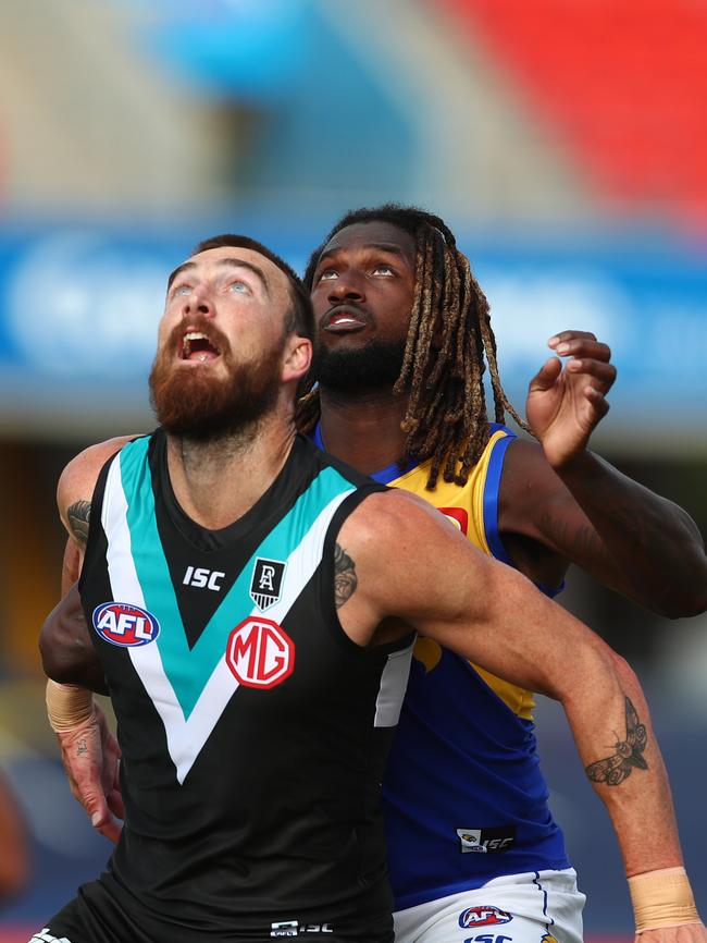 Charlie Dixon takes front position in a ruck contest against Nic Naitanui.