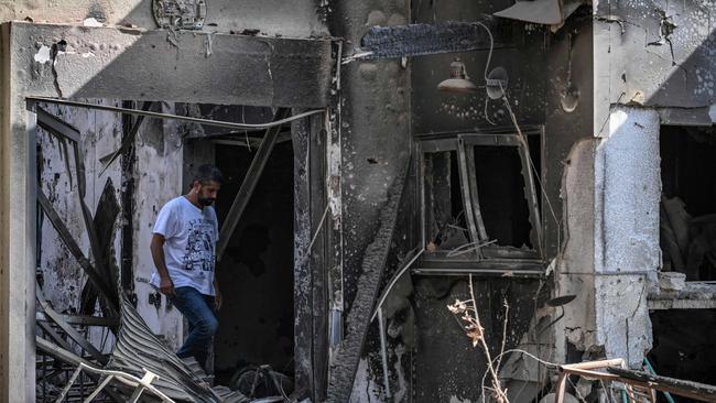 A man walks in a destroyed house in Kibbutz Beeri in southern Israel. Picture: AFP