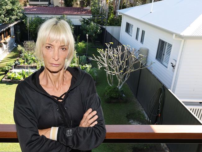 While some people have welcomed changes to granny flat laws for housing and financial relief, resident Annette Spanski says the flipside could be the death of the Gold Coast backyard. She has some monstrosity built up against her back fence, (the giant white house is allegedly a granny flat) and the resulting shadow is killing her garden. Picture Glenn Hampson