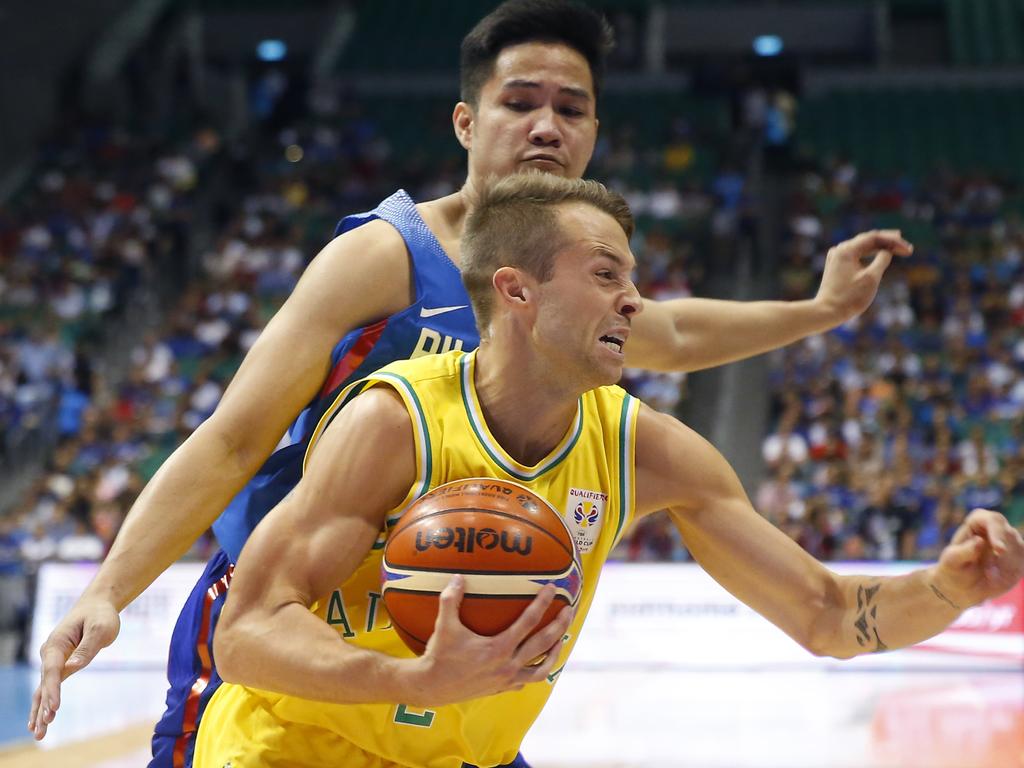 Australia's Nathan Sobey, foreground, drives past the Philippines' Roger Ray Pogoy during the FIBA World Cup Qualifiers Monday, July 2, 2018 at the Philippine Arena in suburban Bocaue township, Bulacan province north of Manila, Philippines. Australia defeated the Philippines 89-53 via default following a brawl in the third quarter. (AP Photo/Bullit Marquez)