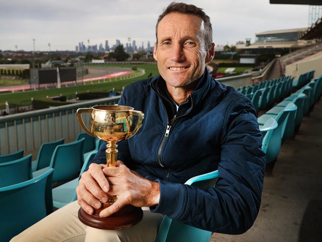 Champion jockey Damien Oliver retiring from horse racing. Damien in the stands holding one of his Melbourne Cups at Moonee Valley.                      Picture: David Caird