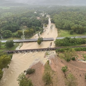 Aerial view of Ollera Creek bridge, which was severed by flood waters, north of Townsville on the Bruce Highway. Picture: Ergon Energy.