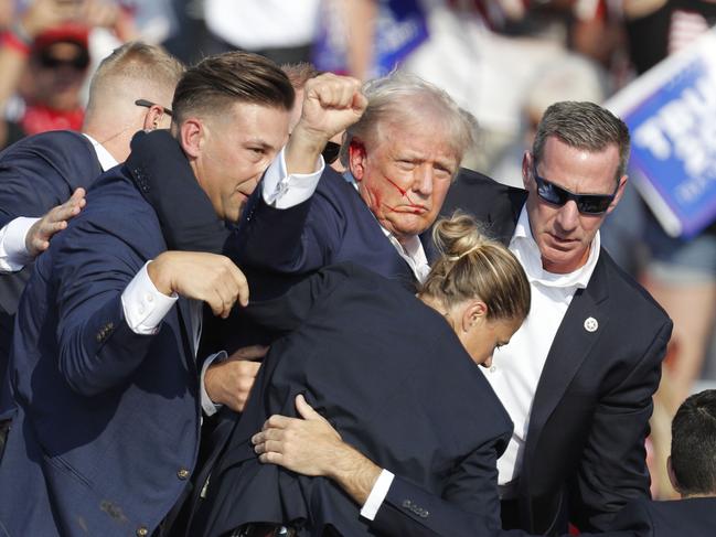 epa11476882 Former US President Donald Trump is rushed off stage by secret service after an incident during a campaign rally at the Butler Farm Show Inc. in Butler, Pennsylvania, USA, 13 July 2024. Former US President Donald Trump stated on social media that a bullet pierced the upper part of his right ear and that a person attending the rally was killed, another was injured and that the alleged shooter was dead. EPA/DAVID MAXWELL