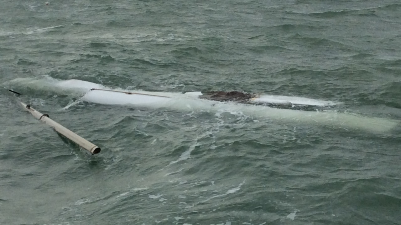 Father and son rescued after spending night in crocodile-infested waters