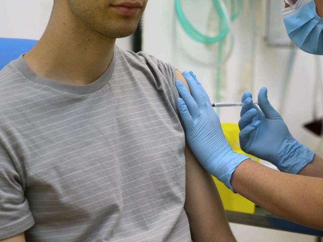 In this screen grab from video issued by Britain's Oxford University, a volunteer is injected with either an experimental COVID-19 vaccine or a comparison shot as part of the first human trials in the U.K. to test a potential vaccine, led by Oxford University in England on April 25, 2020. About 100 research groups around the world are pursuing vaccines against the coronavirus, with nearly a dozen in early stages of human trials or poised to start. (University of Oxford via AP)