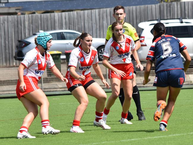 Mele Ketuu runs at (from left) Freya Scully, Sarah Shannon and Abigail Brickwood. Picture: Sean Teuma