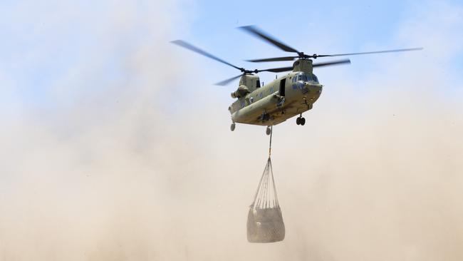 An Australian Army CH-47 Chinook carries hay bales to remote bushfire affected farms on Kangaroo Island during Operation Bushfire Assist in 2020.