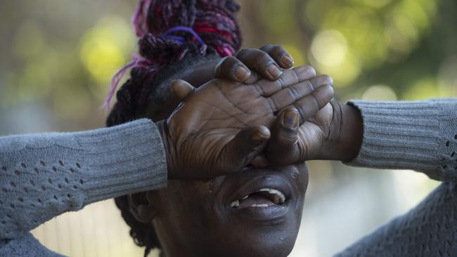 An emotional neighbour Korkoi Aranh talks with media as Police and forensic teams set up crime scene where a mans body was discovered in an apartment in Auburn. Picture: NewsWire / Jeremy Piper