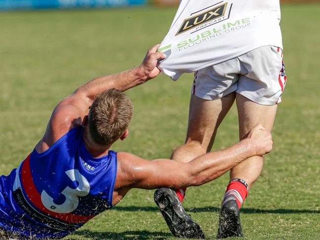 Mornington captain Chris Baker tackles Karingal's Seth Kelly. Picture: Alan Dillon