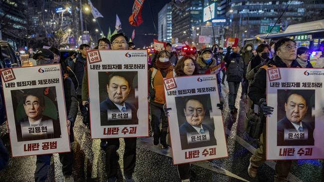 Protesters take part in a demonstration against South Korean President Yoon Suk Yeol in Seoul on Thursday night. Picture: Getty Images